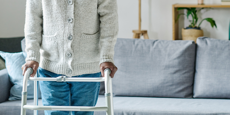 HME Walker Being Used to Walk through a Living Room. 