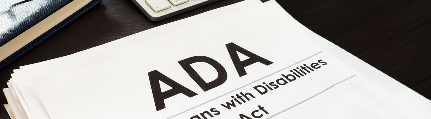 Americans with Disabilities Act papers on tabletop with keyboard