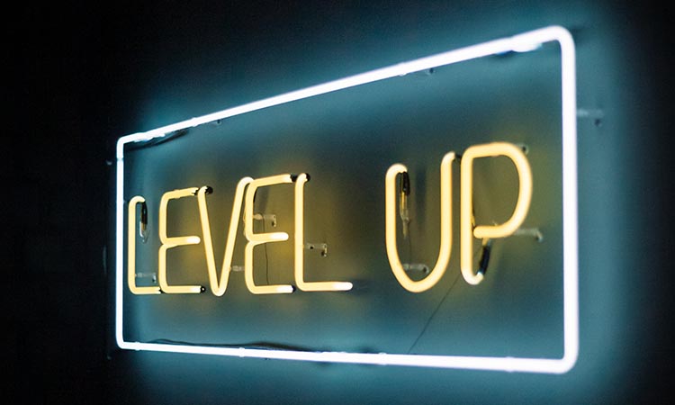 neon sign at an angle with the words Level Up